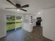 Well-lit kitchen features stainless steel appliances, white cabinets, and a sliding glass door to the backyard at 2575 King Ave, Auburndale, FL 33823