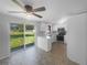 Well-lit kitchen features stainless steel appliances, white cabinets, and a sliding glass door to the backyard at 2575 King Ave, Auburndale, FL 33823