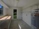 The laundry room offers natural light, a utility sink, storage shelves, and washer/dryer hookups at 2575 King Ave, Auburndale, FL 33823