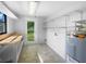 The laundry room offers natural light, a utility sink, storage shelves, and washer/dryer hookups at 2575 King Ave, Auburndale, FL 33823