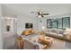 Bright living room with neutral paint, ceiling fan, contemporary furniture, and large windows at 2575 King Ave, Auburndale, FL 33823