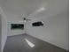 Spacious living room with multiple windows allowing natural light and carpeting at 2575 King Ave, Auburndale, FL 33823