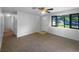 Bright living room featuring a ceiling fan and a large window for natural light at 2575 King Ave, Auburndale, FL 33823