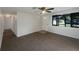 Bright living room featuring a ceiling fan and a large window for natural light at 2575 King Ave, Auburndale, FL 33823