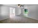 Spacious living room featuring carpet flooring, adjacent rooms, and natural light at 2575 King Ave, Auburndale, FL 33823