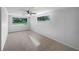 This living room features neutral walls and carpet and a ceiling fan at 2575 King Ave, Auburndale, FL 33823