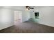 Open living space with transitions to other rooms, carpeted area, and natural lighting at 2575 King Ave, Auburndale, FL 33823