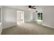 Open living space with transitions to other rooms, carpeted area, and natural lighting at 2575 King Ave, Auburndale, FL 33823