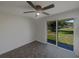 Living room featuring sliding doors to backyard and neutral vinyl flooring at 2575 King Ave, Auburndale, FL 33823