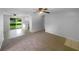 Spacious living room adjacent to kitchen featuring carpet flooring, ceiling fans, and natural light at 2575 King Ave, Auburndale, FL 33823