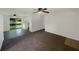Spacious living room adjacent to kitchen featuring carpet flooring, ceiling fans, and natural light at 2575 King Ave, Auburndale, FL 33823