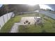 A well-maintained backyard with a paved patio, green grass, and a white fence for privacy at 3028 Lakes Crest Ave, St Cloud, FL 34772