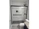Modern bathroom showcasing a tiled glass shower with black trim, black fixtures, and hexagon flooring at 3028 Lakes Crest Ave, St Cloud, FL 34772