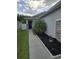 Inviting home entrance with a palm tree, landscaped garden, and a pathway to the front door at 3028 Lakes Crest Ave, St Cloud, FL 34772