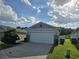 Attractive single-story home with a two-car garage, stone accents, and a well-manicured lawn at 3028 Lakes Crest Ave, St Cloud, FL 34772