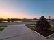 Scenic view of a tranquil pond at sunset, reflecting the colorful sky and surrounding homes at 3028 Lakes Crest Ave, St Cloud, FL 34772