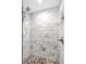 Close-up of the tiled walk-in shower with pebble floor at 322 E Central Blvd # 614, Orlando, FL 32801