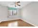 Bedroom with a ceiling fan, wood floors, and large window for plenty of natural light at 322 E Central Blvd # 614, Orlando, FL 32801