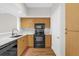 Kitchen featuring stainless steel appliances, wooden cabinets, and stone countertops at 322 E Central Blvd # 614, Orlando, FL 32801