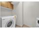 Convenient laundry room features a washer, dryer, and upper cabinets for storage at 322 E Central Blvd # 614, Orlando, FL 32801