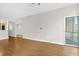 Open-concept living room with wood flooring, access to the balcony, and views of the city at 322 E Central Blvd # 614, Orlando, FL 32801