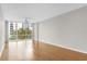 Bright living room featuring wood floors, a ceiling fan, and a large window with a tree view at 322 E Central Blvd # 614, Orlando, FL 32801