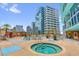 Resort-style pool deck features a relaxing hot tub, lounge chairs, and views of the city skyline at 322 E Central Blvd # 614, Orlando, FL 32801