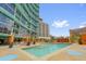 Large community pool featuring clear water, lounge chairs, and views of the surrounding buildings at 322 E Central Blvd # 614, Orlando, FL 32801