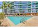Exterior view of the community pool with lounge chairs and an upscale condominium in the background at 322 E Central Blvd # 614, Orlando, FL 32801
