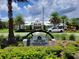 The Lakes Amenities Center with lush landscaping, palm trees and white work truck with lift at 3458 Sagebrush St, Harmony, FL 34773