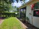 Lush backyard featuring a well-maintained lawn, a privacy hedge, and colorful plants at 3458 Sagebrush St, Harmony, FL 34773
