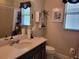 Well-lit bathroom with a modern vanity, stylish fixtures, and a coordinated color scheme at 3458 Sagebrush St, Harmony, FL 34773