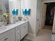 Clean bathroom featuring dual sinks, vanity with white cabinets, and a walk-in closet at 3458 Sagebrush St, Harmony, FL 34773
