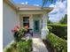 Inviting covered front porch with a teal door and cozy seating area at 3458 Sagebrush St, Harmony, FL 34773