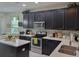 Close-up of the kitchen featuring stainless appliances, dark cabinets, and white countertops at 3458 Sagebrush St, Harmony, FL 34773