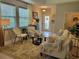 Bright and airy living room featuring neutral tones, stylish furnishings, and large windows at 3458 Sagebrush St, Harmony, FL 34773
