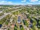 Aerial view showcasing community, nearby highway, and lush tree coverage at 3507 W Jefferson St, Orlando, FL 32805