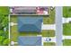 An aerial perspective of a well-maintained neighborhood highlighting the rooftops and lawns at 3507 W Jefferson St, Orlando, FL 32805