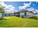 A backyard features a screened lanai, lush lawn, and a privacy fence at 3507 W Jefferson St, Orlando, FL 32805