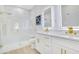 Elegant bathroom featuring a walk-in shower, double vanity with gold fixtures, and modern lighting for a spa-like experience at 3507 W Jefferson St, Orlando, FL 32805