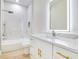 Modern bathroom boasts a walk-in shower, a tub, stylish vanity with gold fixtures, and contemporary design elements at 3507 W Jefferson St, Orlando, FL 32805