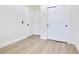 Bright bedroom features light wood floors, white walls, and closet with sliding doors at 3507 W Jefferson St, Orlando, FL 32805