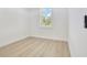 Cozy bedroom with natural light from the window and light wood flooring at 3507 W Jefferson St, Orlando, FL 32805