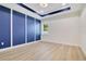 Inviting bedroom features a modern accent wall and a window offering natural light and serene views at 3507 W Jefferson St, Orlando, FL 32805