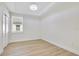 Cozy bedroom featuring a window, light colored walls and flooring, and a closet with sliding doors for seamless storage at 3507 W Jefferson St, Orlando, FL 32805