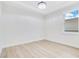 Bright bedroom features a large window, light walls and floors, and a modern ceiling fan for added comfort and style at 3507 W Jefferson St, Orlando, FL 32805