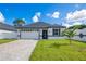 Beautiful home with a manicured lawn and a driveway leading to an attached two car garage at 3507 W Jefferson St, Orlando, FL 32805