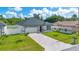 Charming single-story home featuring a well-kept lawn and a stylish gray-and-white exterior at 3507 W Jefferson St, Orlando, FL 32805