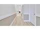 Bright hallway with modern flooring and neutral paint, leading to the kitchen at 3507 W Jefferson St, Orlando, FL 32805