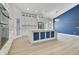 Bright kitchen features a large island with seating, modern appliances, and a stylish design with a blue accent wall at 3507 W Jefferson St, Orlando, FL 32805